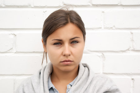 Cute young girl portrait, looking at camera, sadの写真素材