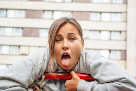 Cheerful young girl. Makes funny facial expressionsの写真素材
