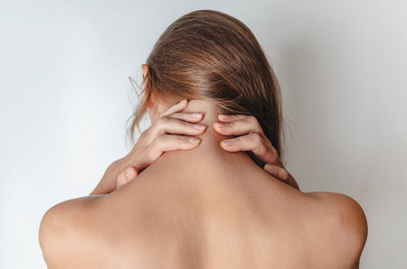 Close up woman with bare shoulders, hands behind her head. rear view. SPA treatments.の写真素材