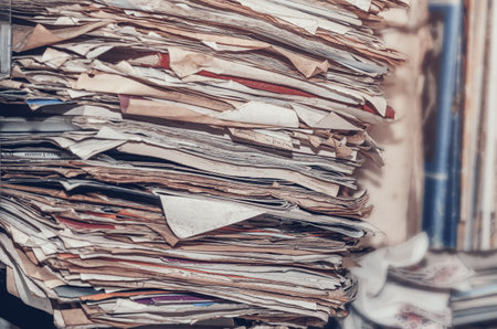 Documents, old papers in folders on shelves are stacked in a messの写真素材