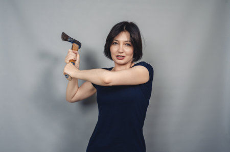 Woman with ax in hands. Threatening facial expression.の写真素材