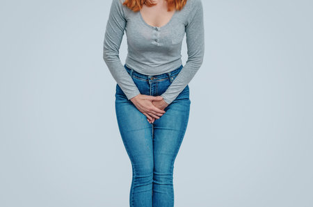 The woman pressed the hands in the lower abdomen, feels pain in the uterus. Gynecological conceptの写真素材