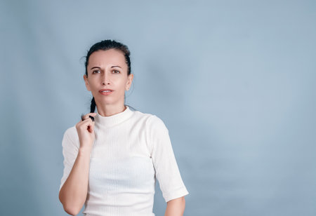 Thin middle-aged woman on gray background