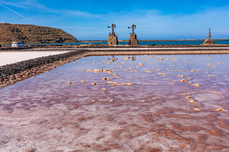 Windmills on the coast. Seascape with windmills and mountains under blue sky.の写真素材