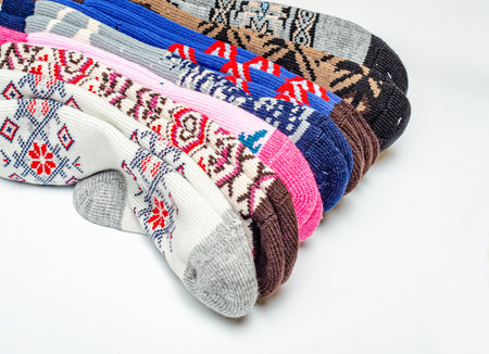 Warm wool socks folded on white background