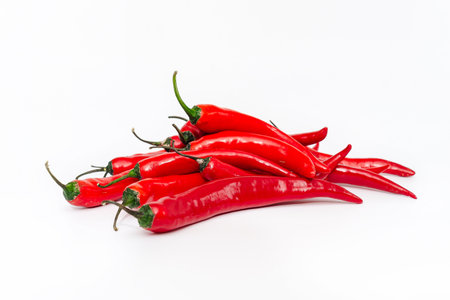 Bunch of long red chili peppers on white background isolated. Vitamins, healthy food.