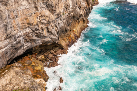 White foam waves breaks against rocks. Travel concept. Klungkung, Bali Indonesiaの写真素材