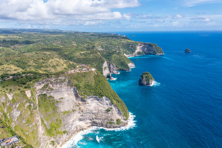 Sea, rocky mountains covered with forest. Big stones in water. Vacation. Klungkung. Bali Indonesiaの写真素材
