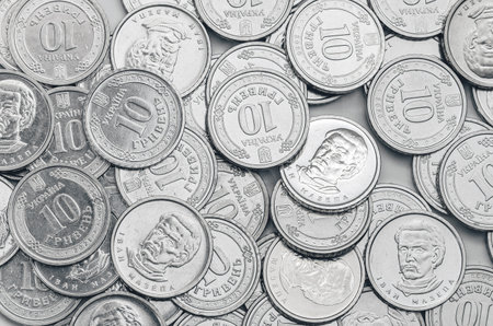 Ukrainian money, exchange coin, white coins denomination of 10 hryvnias in random order. Top viewの写真素材