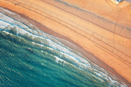 sandy beach near the sea, a bird-eye view of the shoreの写真素材