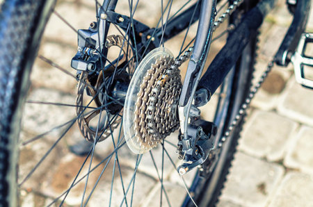 Part of bicycle after washing at car wash. Clean wet wheel with spokes, chain and pedal. Activityの写真素材