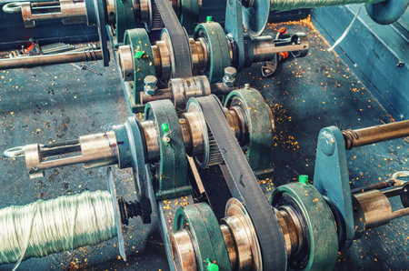 Close up industrial machine with metal shafts and plates. Coils for winding wire. Industrial viewの写真素材
