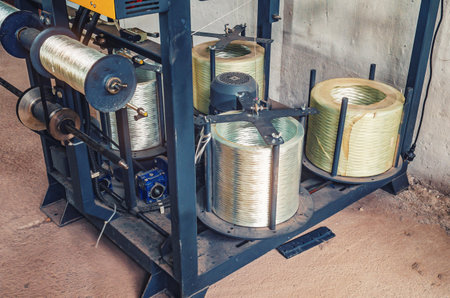 Coils of plastic wire in workshop. Spinning and winding of plastic coils of wire in modern factoryの写真素材