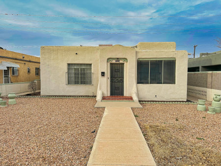 ALBUQUERQUE, NEW MEXICO, USA - March 9, 2023. Wooden mud houses. Wooden windows and doors. Bush near houseのeditorial素材