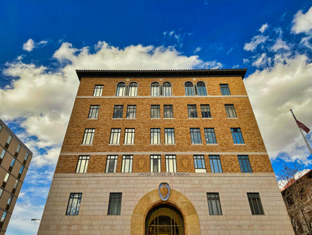 ALBUQUERQUE, NEW MEXICO, USA - March 8, 2023. Low angle view of federal courthouse against blue sky with white cloudsのeditorial素材
