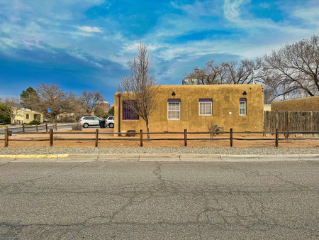 ALBUQUER9UE, NEW MEXICO, USA - March 7, 2023. Wooden mud houses. Wooden windows and doors. Bush and tree near houseのeditorial素材
