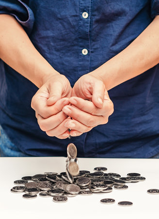 Business woman hands holding currency coinsの写真素材