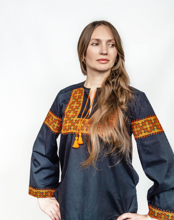 Elegant Portrait of a Woman Wearing Black Ukrainian Embroidered Vyshyvanka on a Clean White...