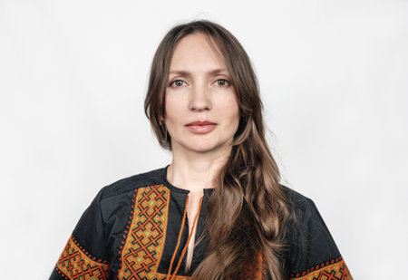 Beautiful Woman in Black Ukrainian Embroidered Vyshyvanka: Studio Portrait on White Background