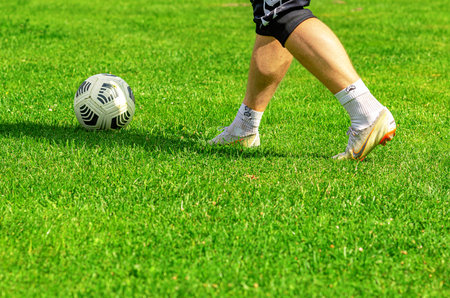 Young man Hand Putting Football Sport Field With Leisure Activities Concept, A Brand New Soccer Ballの写真素材