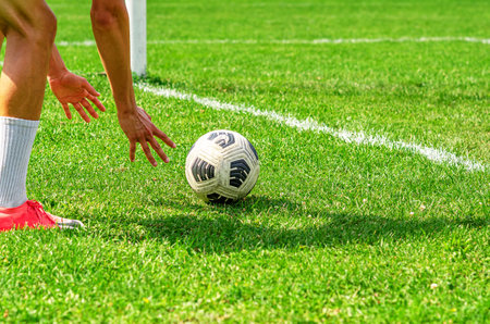 Young man Hand Putting Football Sport Field With Leisure Activities Concept, Brand New Soccer Ballの写真素材
