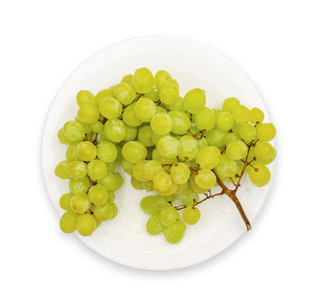 Juicy delicious fresh grapes on white plate. Isolated on white. Vitamins, fruits, healthy food.の写真素材