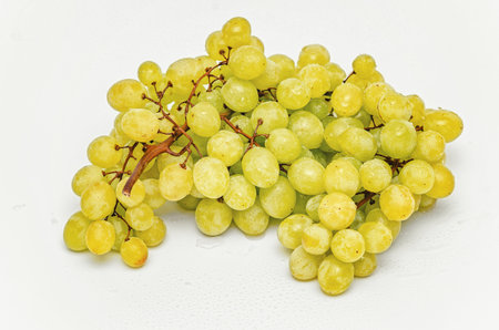 Juicy big bunch of green grapes on white background. View top. Production fruit juicesの写真素材