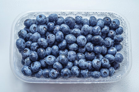 Box with fresh blueberries isolated on white. Top view. Concept of healthy eating. Weight lossの写真素材