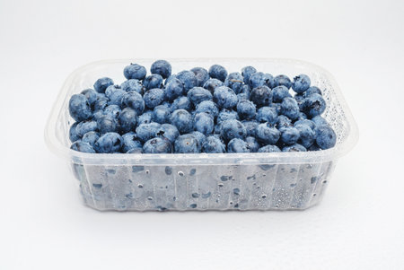Transparent box with fresh blueberries isolated on white. Side view. Antioxidants, vitamins, healthの写真素材