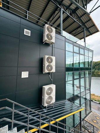 Commercial HVAC system installed on building exterior with glass, steel designの写真素材
