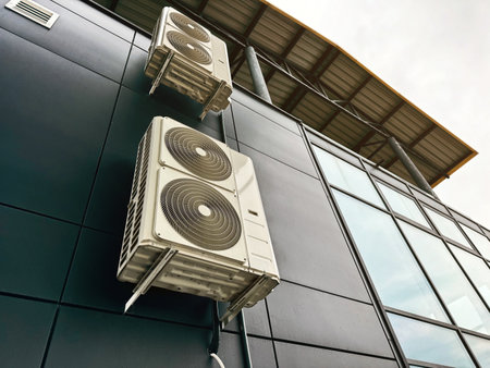 Air conditioning units attached to industrial building with steel structureの写真素材
