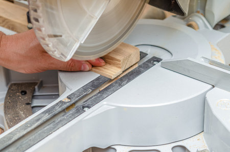 Circular saw in the workshop sawing a small boardの写真素材