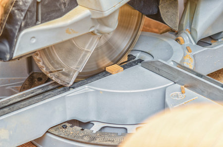 Circular saw in the workshop sawing a small boardの写真素材