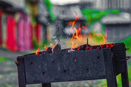 Hearth in a metal brazier. Lighting a fire for cooking barbecue.の写真素材