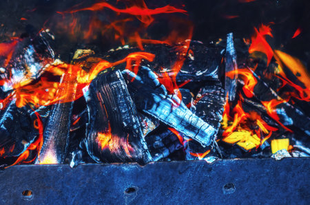 Hearth in a metal brazier. Lighting a fire for cooking barbecue.の写真素材