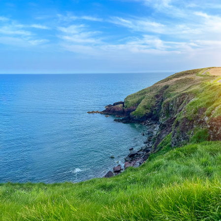 Rocky shore of the ocean. Blue water beyond horizon. Coast of Irelandの写真素材
