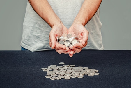 Silver coins in female hands on blurred backdrop. Importance of receiving social financial supportの写真素材