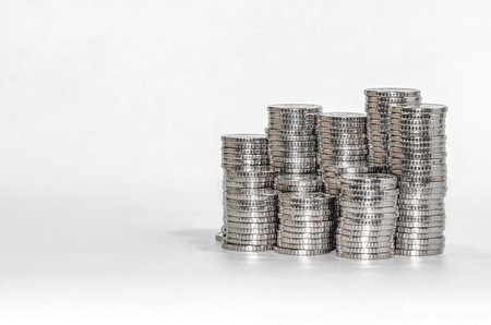 Front view columns of silver coins. Isolated on white. Idea of business and finance. Copy spaceの写真素材