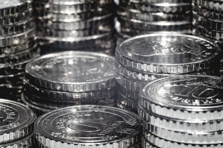 Macro photo of pile of silver coins under light. Background economic trends for business, financialの写真素材