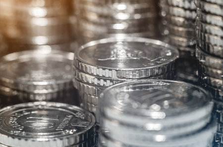 Selective focus of pile of silver coins under light. Background economic trends for business, financialの写真素材