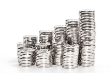 Columns of silver coins. Isolated on white. Idea of development and growth of business and financeの写真素材