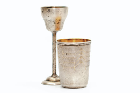 Goblet on high stem with engraving and small silver gilt antique glass. White backgroundの写真素材