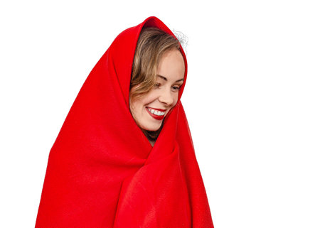 Close up portrait of smiling female model in red scarf on head, isolated on white studio backgroundの写真素材