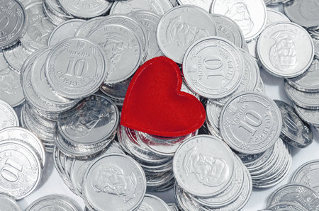 Coins red heart background. Valentine's day concept. Minimal concept. Greeting, postcard, bannerの写真素材
