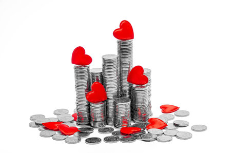 Red hearts on towers of silver coins. Happy Valentine's Day, banner, postcard, money envelope. Copy spaceの写真素材