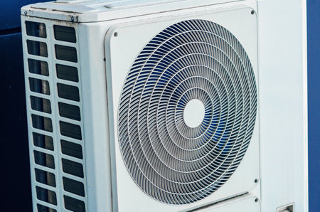 White air conditioner close-up on the wall of modern buildingの写真素材