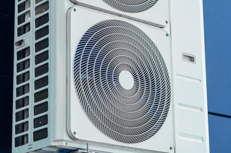 White air conditioner close-up on the wall of modern buildingの写真素材