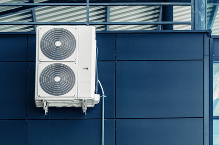 White air conditioner on the wall of a modern building. Ventilation of premisesの写真素材