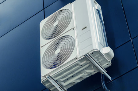 White air conditioner on the wall of a modern building. Ventilation of premisesの写真素材