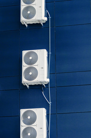 White air conditioner on the wall of a modern building. Ventilation of premisesの写真素材